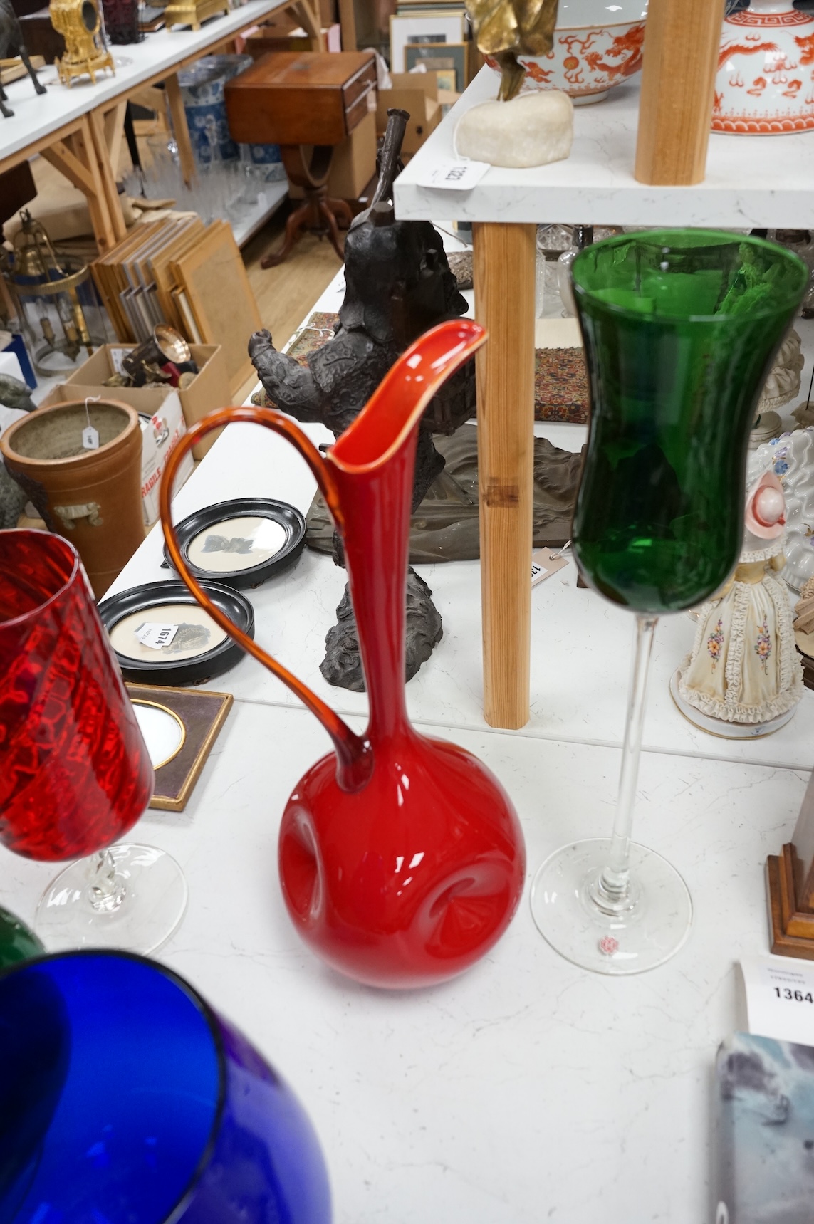 Five pieces of mid-century coloured glassware, to include a jug and an oversized brandy balloon, largest 48cm high